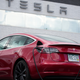 A 2021 Tesla Model 3 sedan sits in a near-empty lot at a Tesla dealership in Littleton, Colo. June 27, 2021.